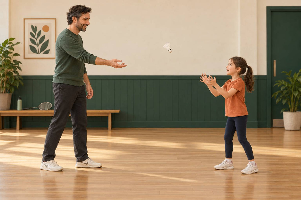 A parent and child begin with an easy shuttle-handling game in a clear, uncluttered practice space.