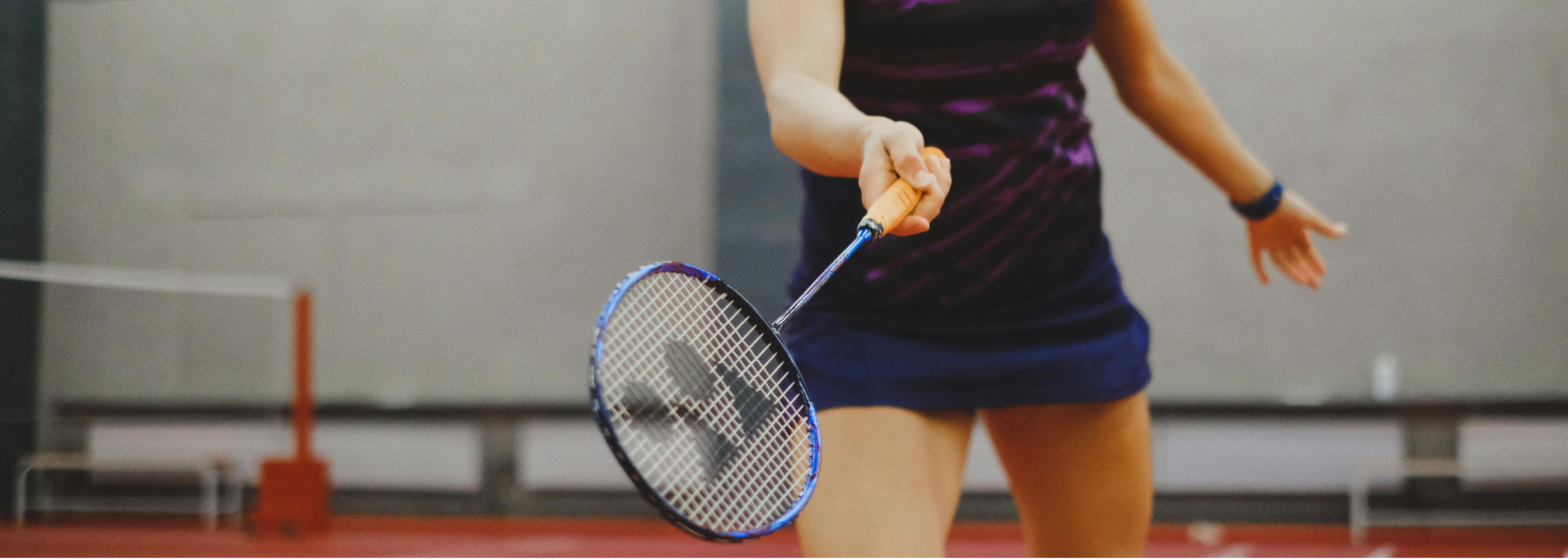 Badminton racket with shuttlecock, representing top brands Yonex, Victor, and Li-Ning for quality gear.